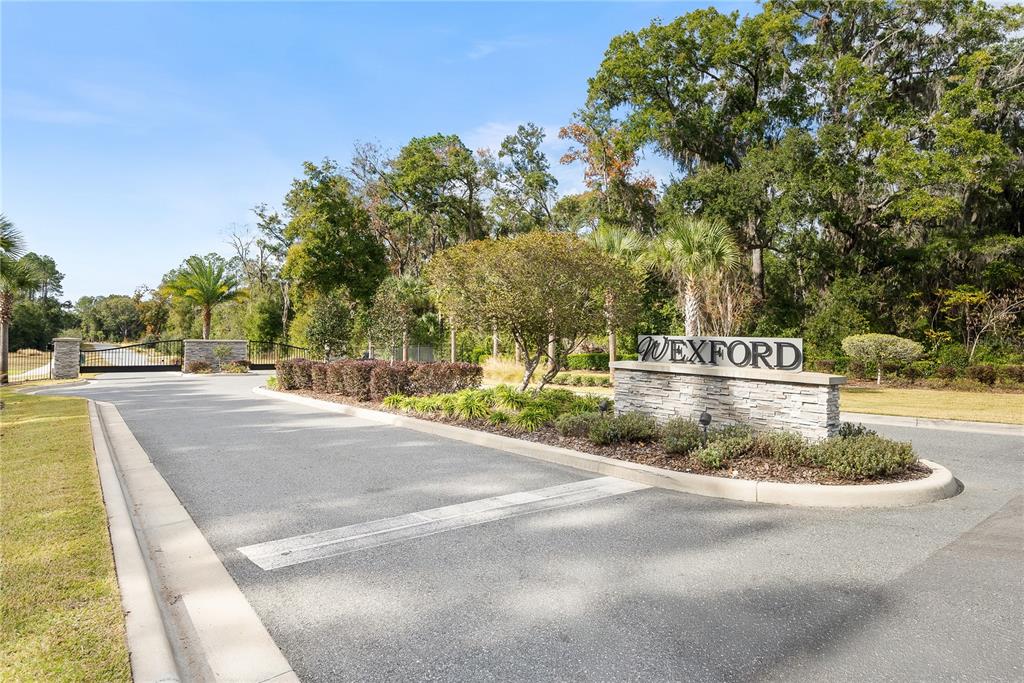 A stone monument sign for Wexford stands at the entrance to a gated community — 12364 SW 16TH LANE, NEWBERRY, FL