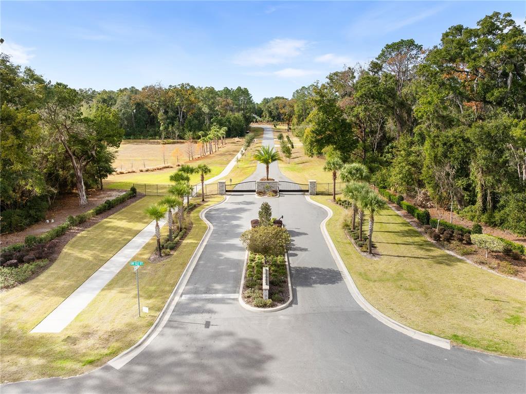 An aerial view shows a gated entrance to a property with a paved driveway — 12364 SW 16TH LANE, NEWBERRY, FL