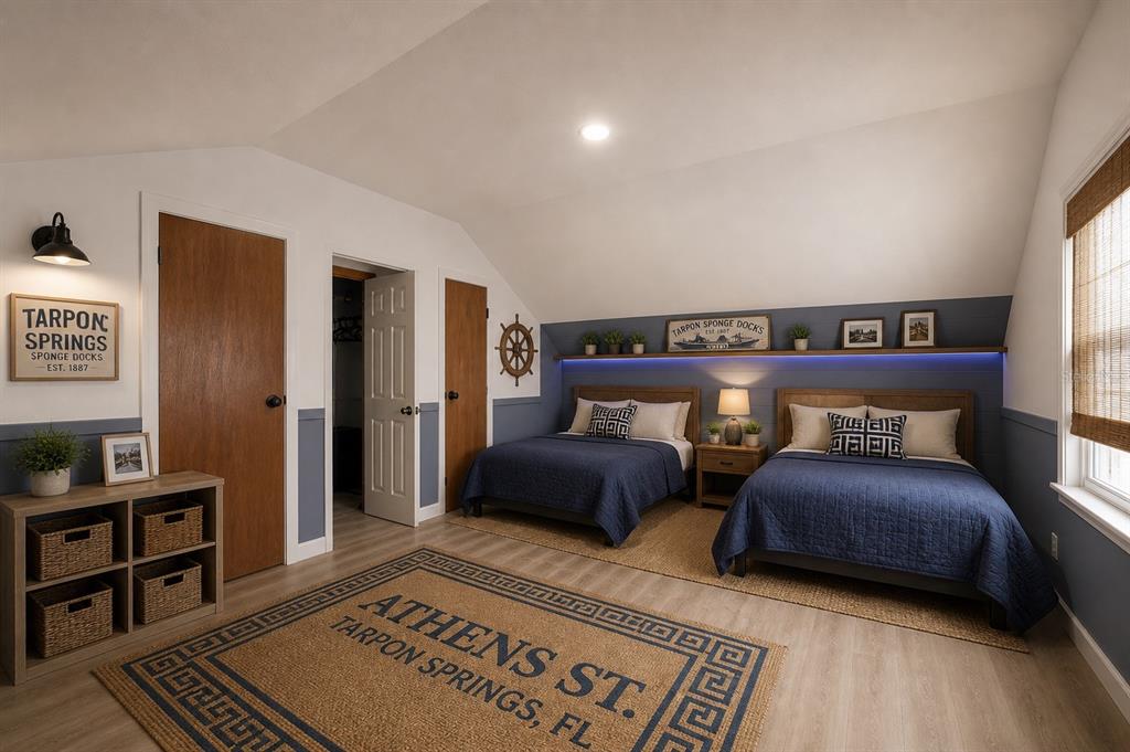 A bedroom features two beds, blue wall paneling, a nautical theme, and a custom rug — 531 ATHENS STREET, TARPON SPRINGS, FL