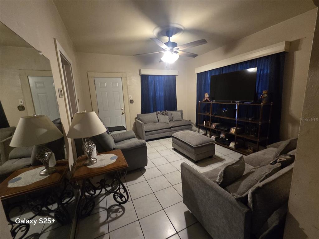 A gray, single-story house with a front porch sits on a corner lot — 1301 E 26TH AVENUE, TAMPA, FL