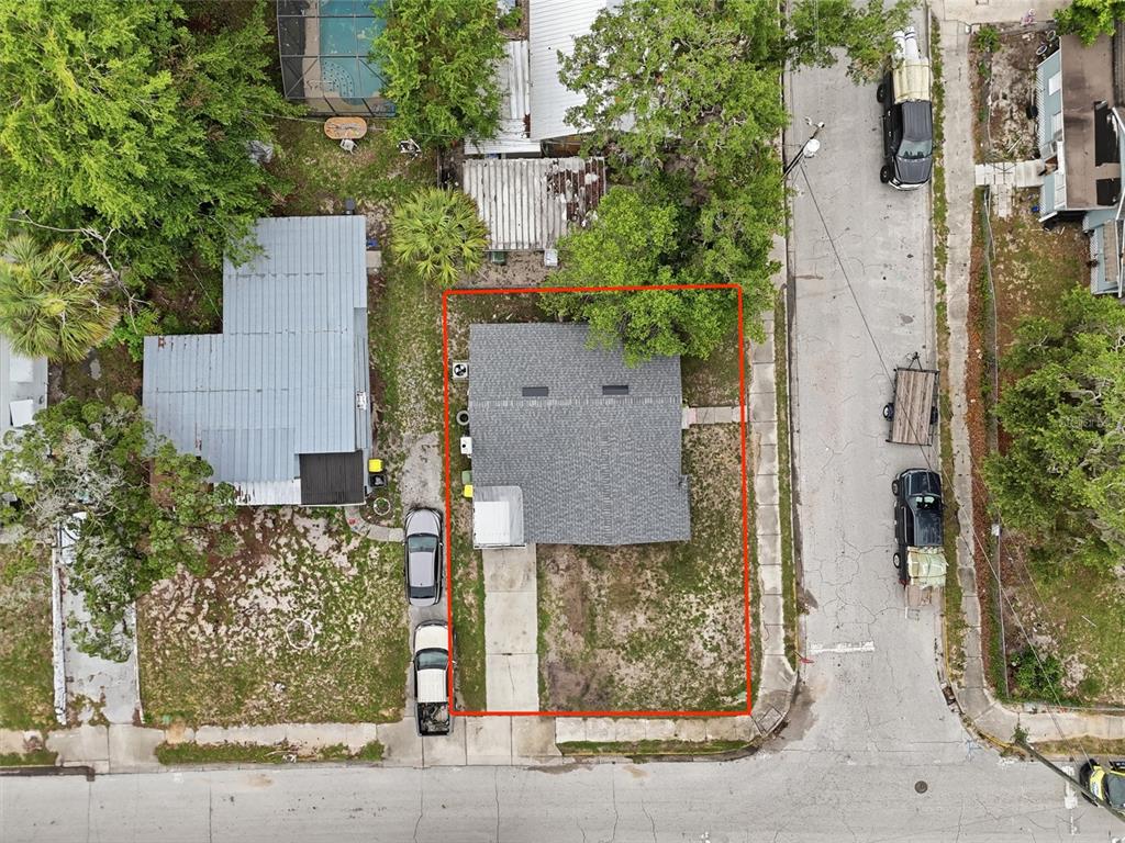 An aerial view shows a single-story house with a gray roof on a corner lot — 1813 HIGH STREET, LEESBURG, FL