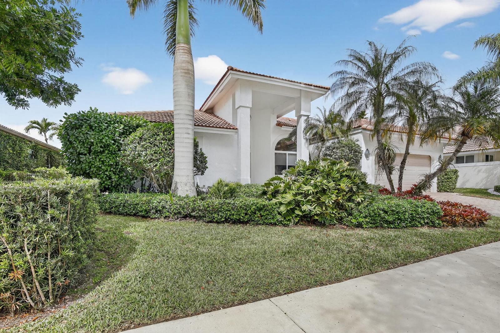 A white single-story house with a tile roof, palm trees, and landscaped front yard — 2647 Miller Court, Weston FL 33332, WESTON, FL