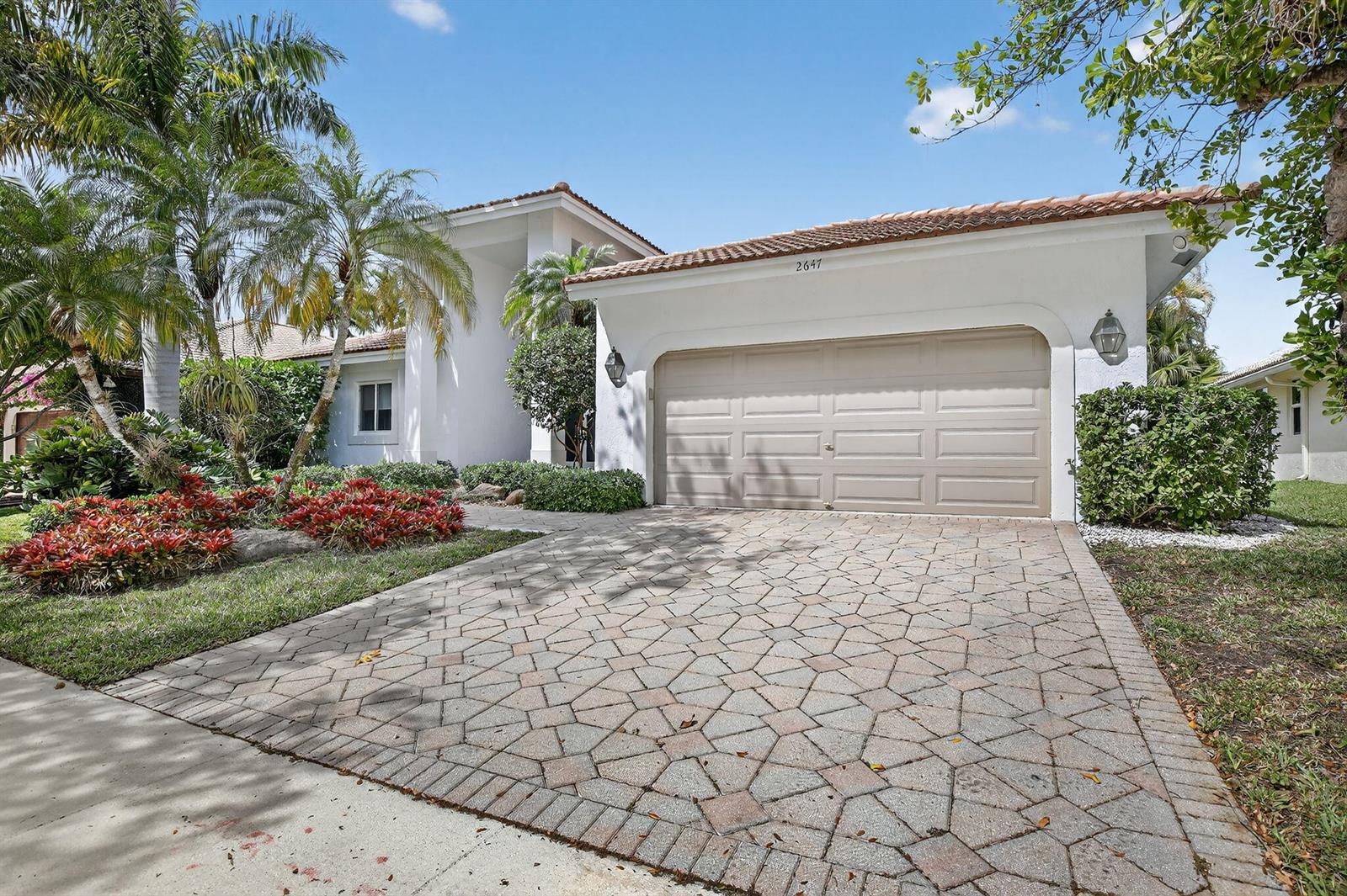 A white house with a tiled roof, a two-car garage, and a patterned paver driveway — 2647 Miller Court, Weston FL 33332, WESTON, FL