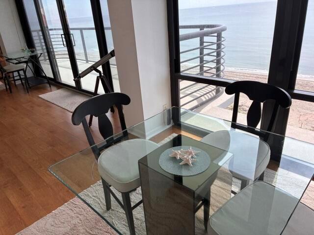 A glass dining table with chairs sits in a room overlooking the ocean — 250 S Ocean Boulevard # 3h, Boca Raton FL 33432, BOCA RATON, FL