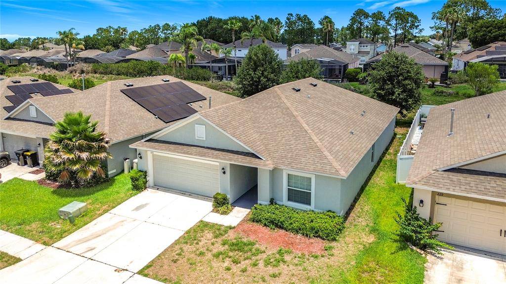 An aerial view shows suburban houses with shingled roofs, driveways, and green lawns — 225 BELLA VERANO WAY, DAVENPORT, FL