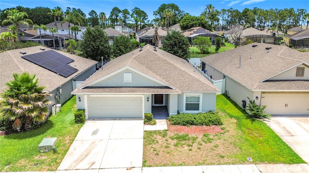 An aerial view of a single-story suburban house with a garage and a brown roof — 225 BELLA VERANO WAY, DAVENPORT, FL