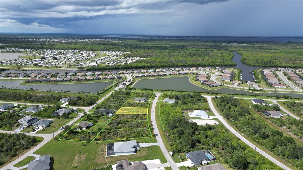 An aerial view shows several residential lots outlined in green within a suburban neighborhood — 8071 THRUSO ROAD, PORT CHARLOTTE, FL