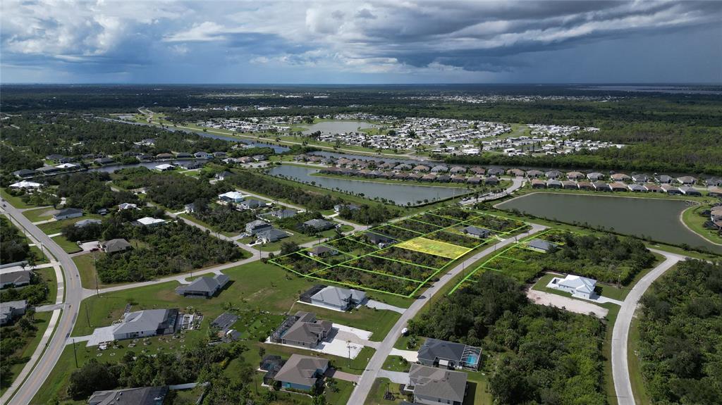 An aerial view shows several vacant residential lots outlined in green within a suburban neighborhood — 8071 THRUSO ROAD, PORT CHARLOTTE, FL