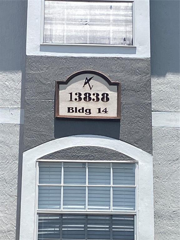 A building exterior showing a sign labeled 13838 Bldg 14 between two windows — 13838 FAIRWAY ISLAND DRIVE UNIT 1413, ORLANDO, FL