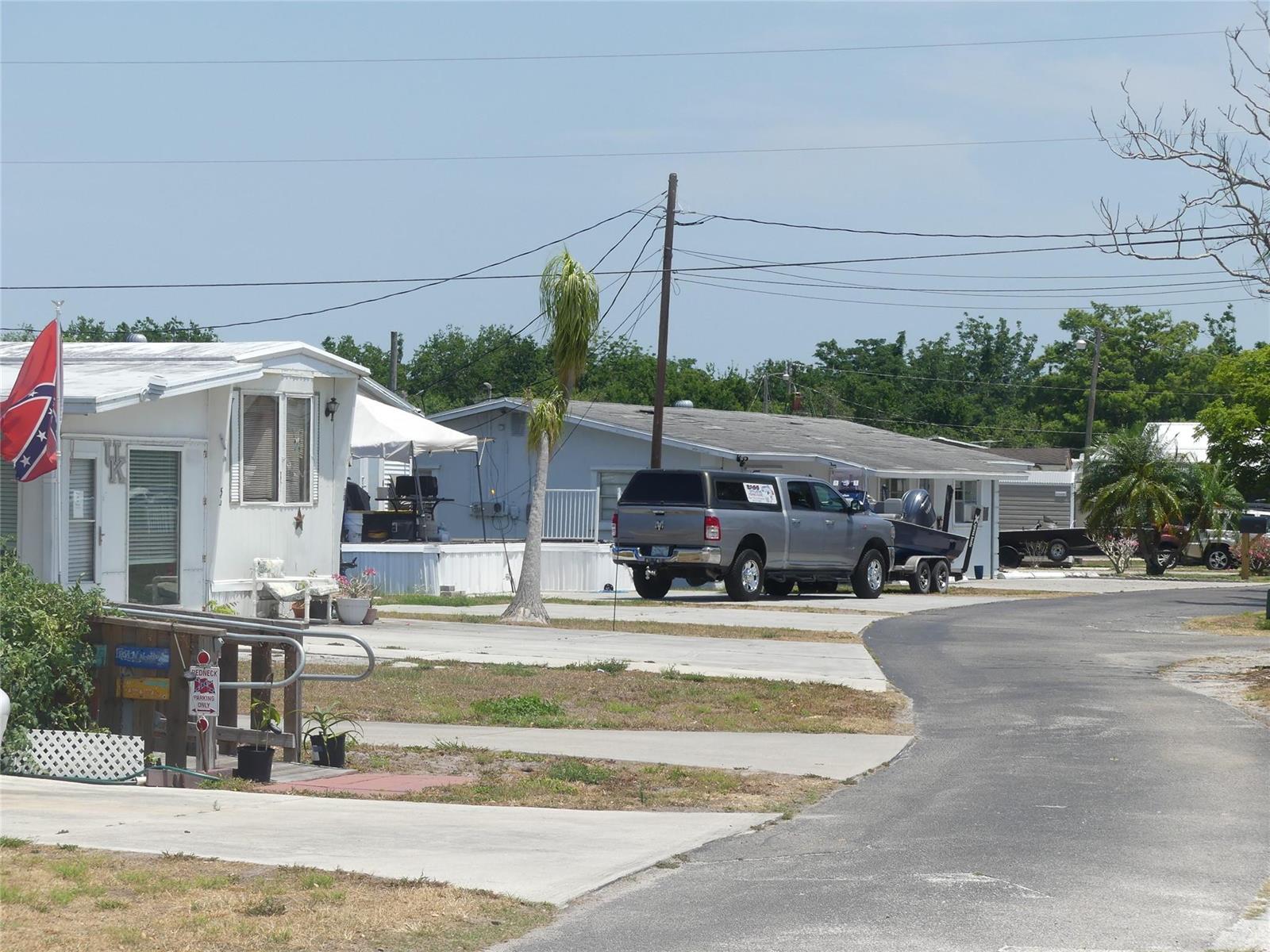 A street view of mobile homes with a parked pickup truck and a boat trailer — 8791 Highway 78, Okeechobee FL 34971, OKEECHOBEE, FL