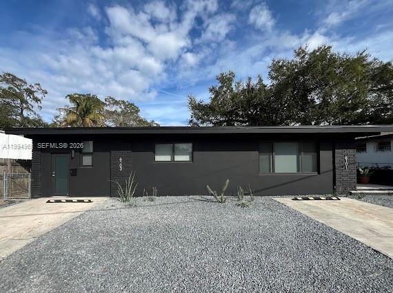 A single-story duplex with a dark exterior, gravel front yard, and two separate entrances — 6101 NE Miami Ct # 2, Miami FL 33137, MIAMI, FL