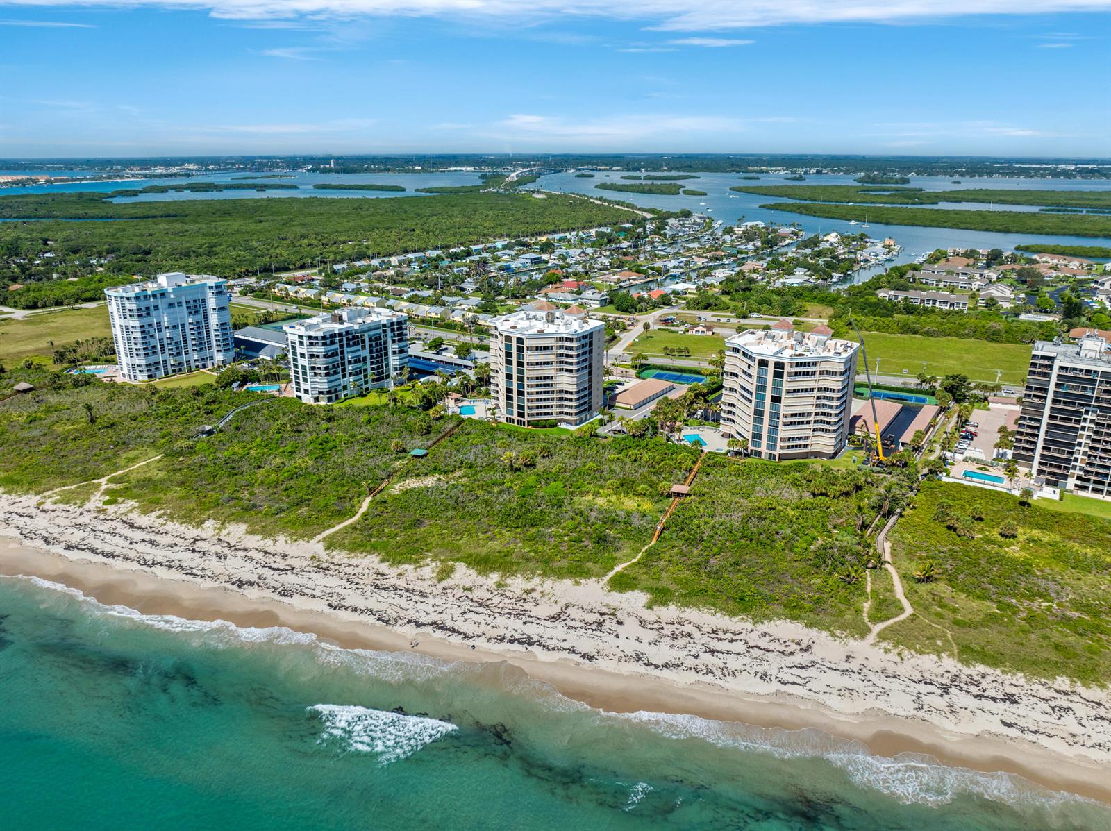 An aerial view shows several high-rise apartment buildings situated along a sandy beach — 2900 N Highway # b, Fort Pierce FL 34949, FORT PIERCE, FL