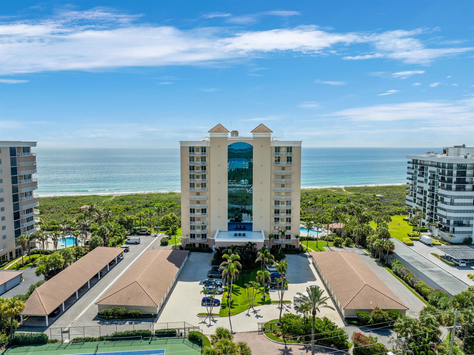 An aerial view shows a multi-story apartment building situated between a parking lot and the ocean — 2900 N Highway # b, Fort Pierce FL 34949, FORT PIERCE, FL
