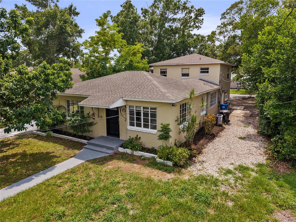 An exterior view of a tan, single-story house with a two-story addition in the back — 4222 18TH STREET N, ST PETERSBURG, FL