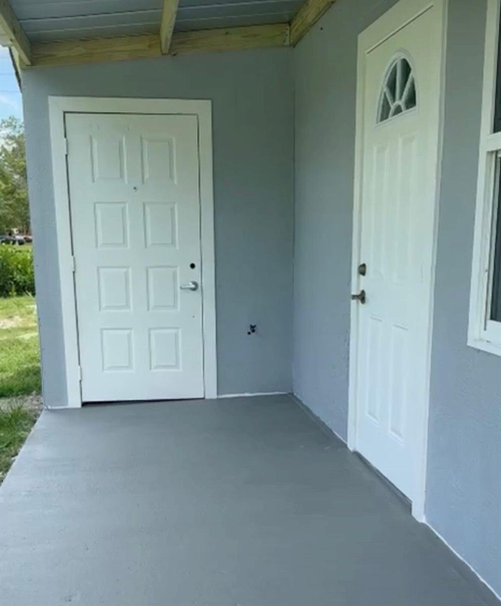 A kitchen features wood-look flooring, stainless steel appliances, and a white-paneled sink area — 9024 Apache Boulevard # A, Loxahatchee FL 33470, LOXAHATCHEE, FL