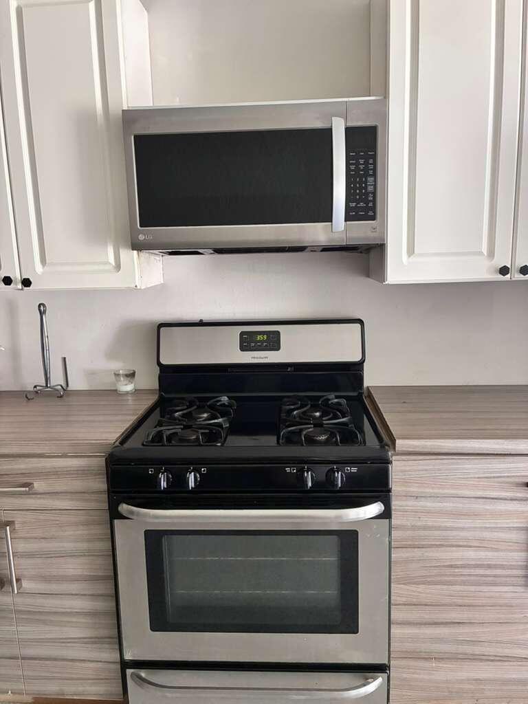 A stainless steel Whirlpool side-by-side refrigerator stands in a room with light-colored walls — 9024 Apache Boulevard # A, Loxahatchee FL 33470, LOXAHATCHEE, FL