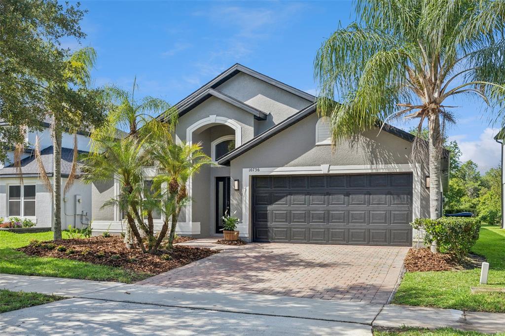 An aerial view shows a clubhouse building with a circular driveway, parking lots, and golf course — 10736 MERE PARKWAY, ORLANDO, FL
