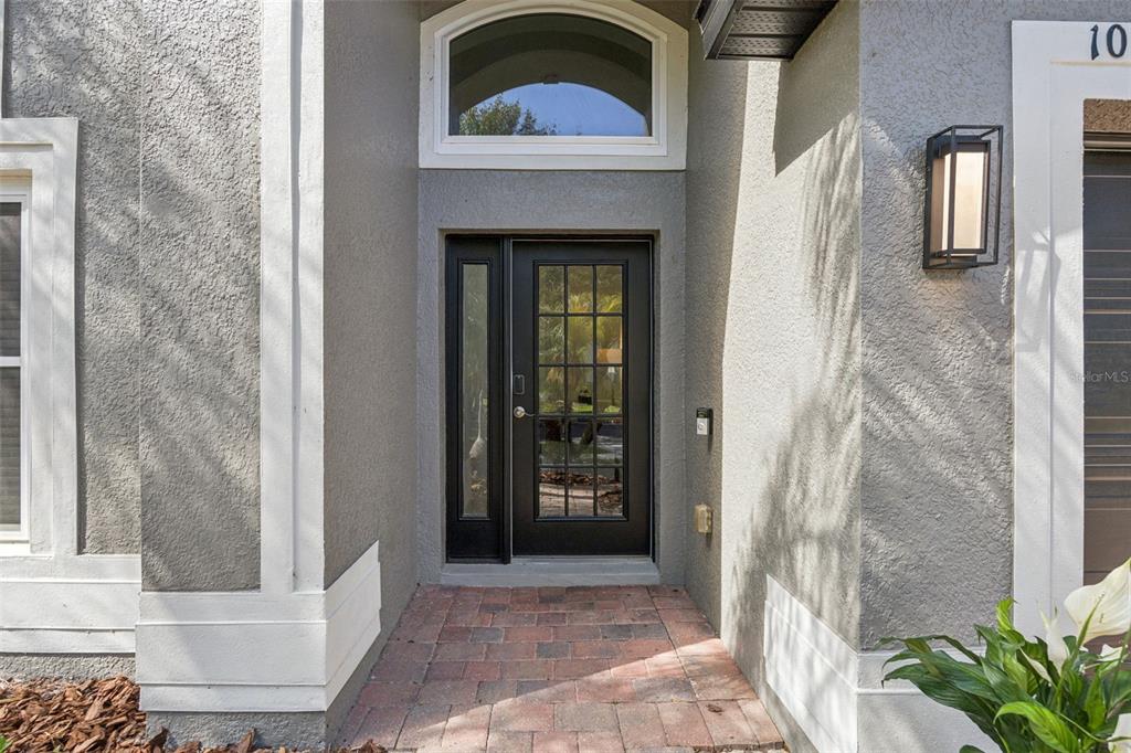 A single-story house with a gray exterior, a two-car garage, and a paved driveway — 10736 MERE PARKWAY, ORLANDO, FL