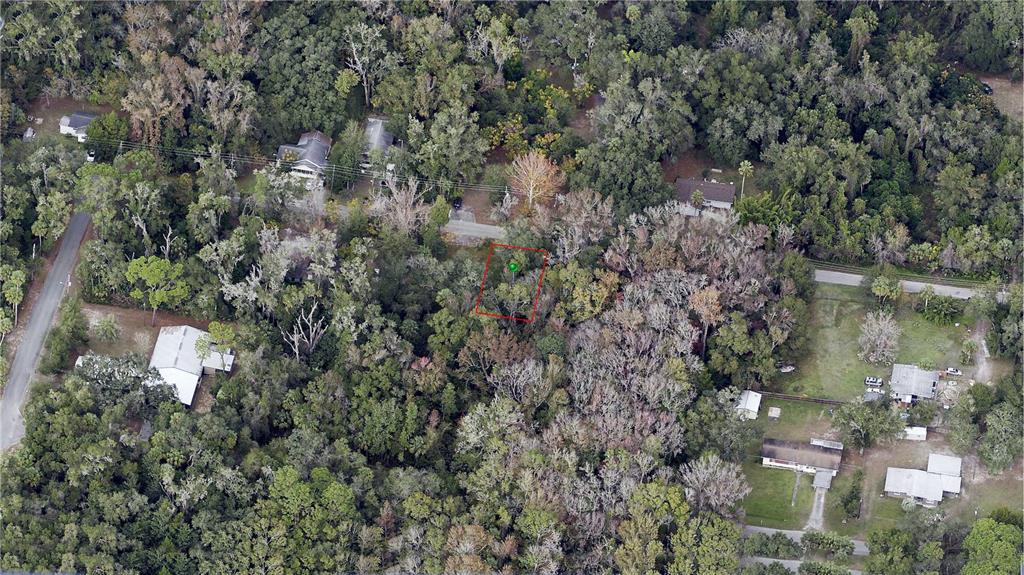 An aerial view shows a wooded lot with a red boundary outline — 358 NE 13TH TERRACE, CRYSTAL RIVER, FL