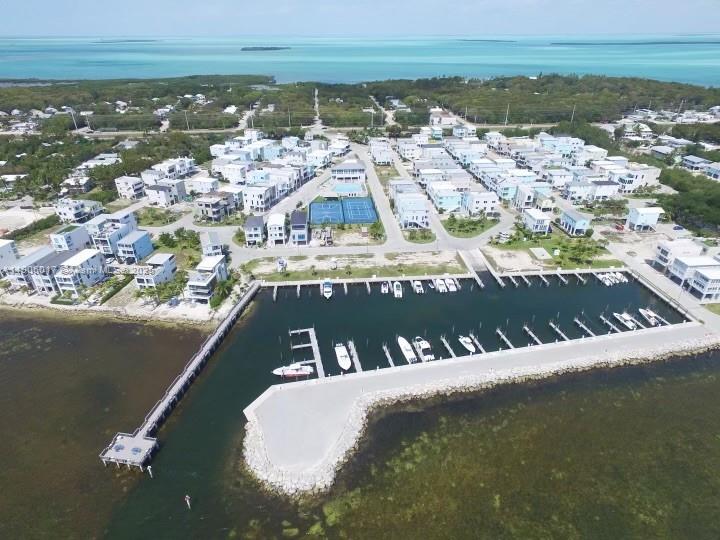 An aerial view shows a coastal residential community with a private marina and boat slips — 94825 Overseas Hwy #262, Key Largo FL 33037, KEY LARGO, FL