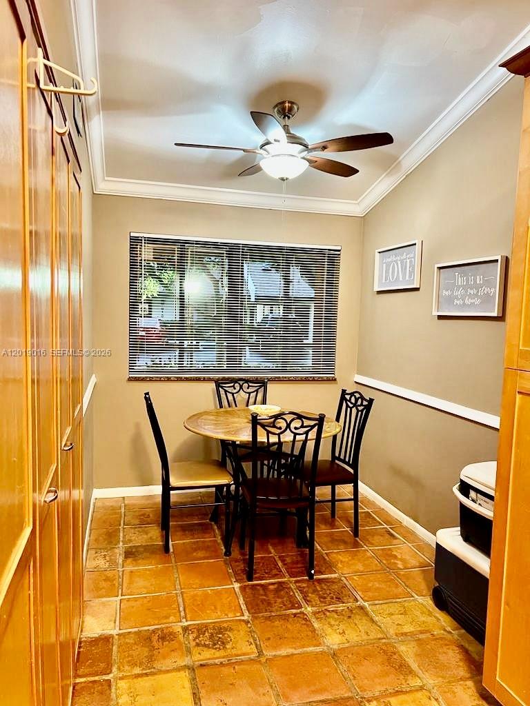 A dining area with a round table, four chairs, tile flooring, and a ceiling fan — 509 NE 199th Ln # 3A, Miami FL 33179, MIAMI, FL