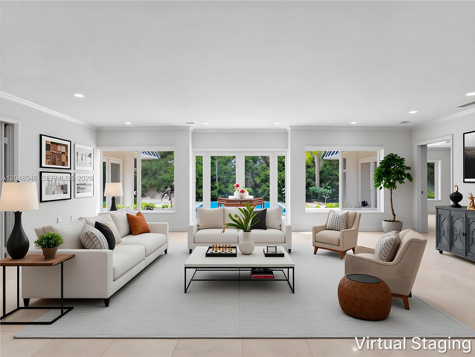 A living room with white sofas, a coffee table, and large windows overlooking a pool — KEY BISCAYNE, FL