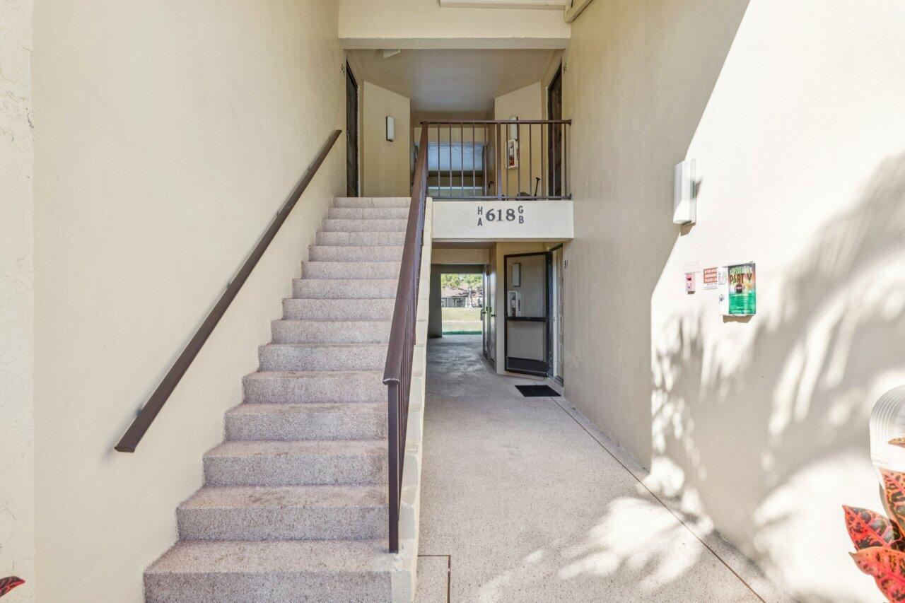 An outdoor staircase leads to an upper-level landing with apartment unit numbers displayed — 618 Sea Pine Way # A2, FL 33415, FL