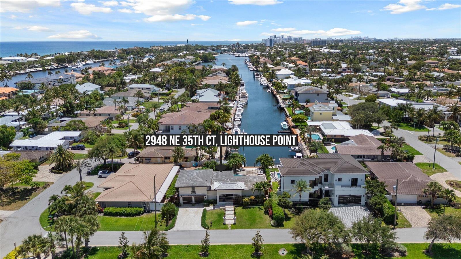 An aerial view shows a waterfront house with a pool and boat dock in Florida — 2948 NE 35th Court, Lighthouse Point FL 33064, LIGHTHOUSE POINT, FL