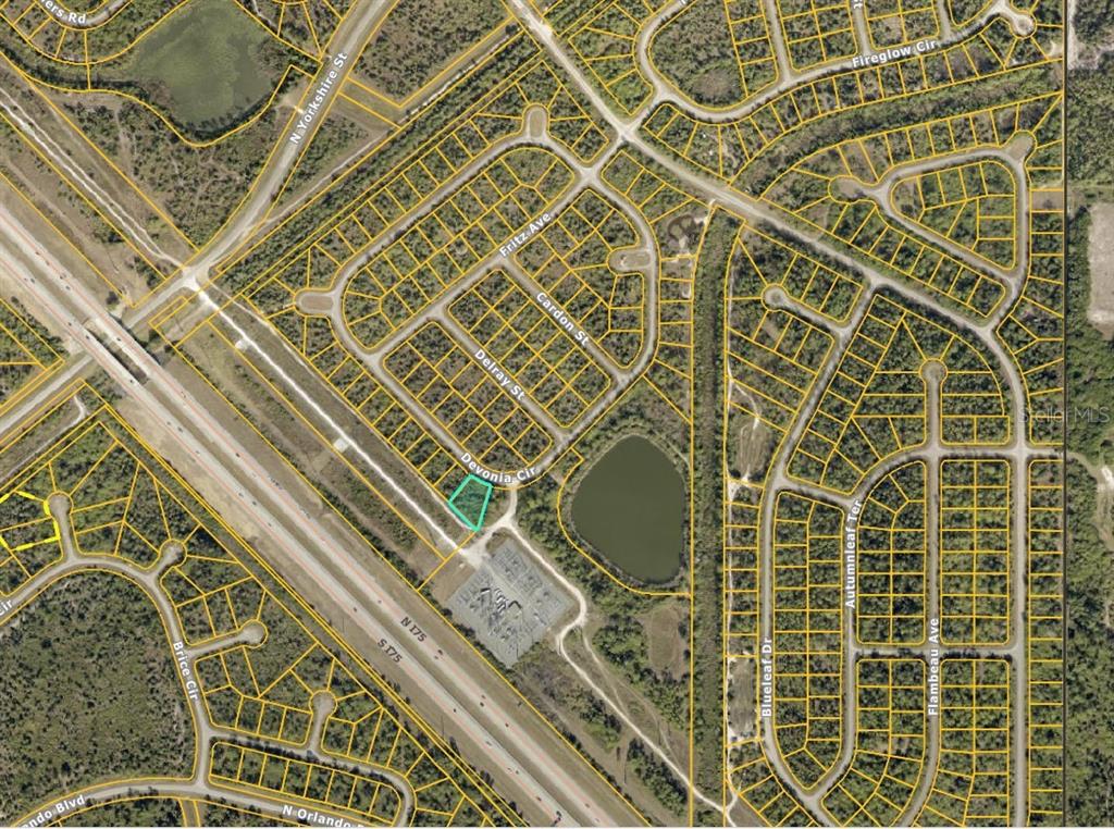 An aerial map shows a highlighted vacant residential lot located near a highway and pond — LOT 1 DEVONIA CIRCLE, NORTH PORT, FL