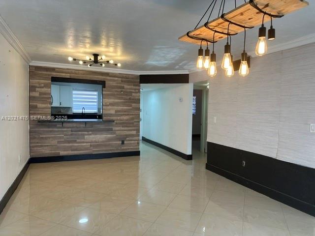 An interior view shows a room with tiled floors, wood-paneled walls, and a hanging light fixture — 6175 W 20th Ave # 309, Hialeah FL 33012, HIALEAH, FL