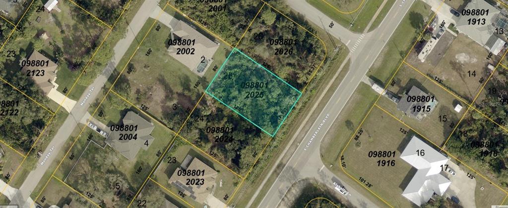 This is an aerial map showing a vacant lot highlighted in blue among residential properties — S CHAMBERLAIN BOULEVARD, NORTH PORT, FL