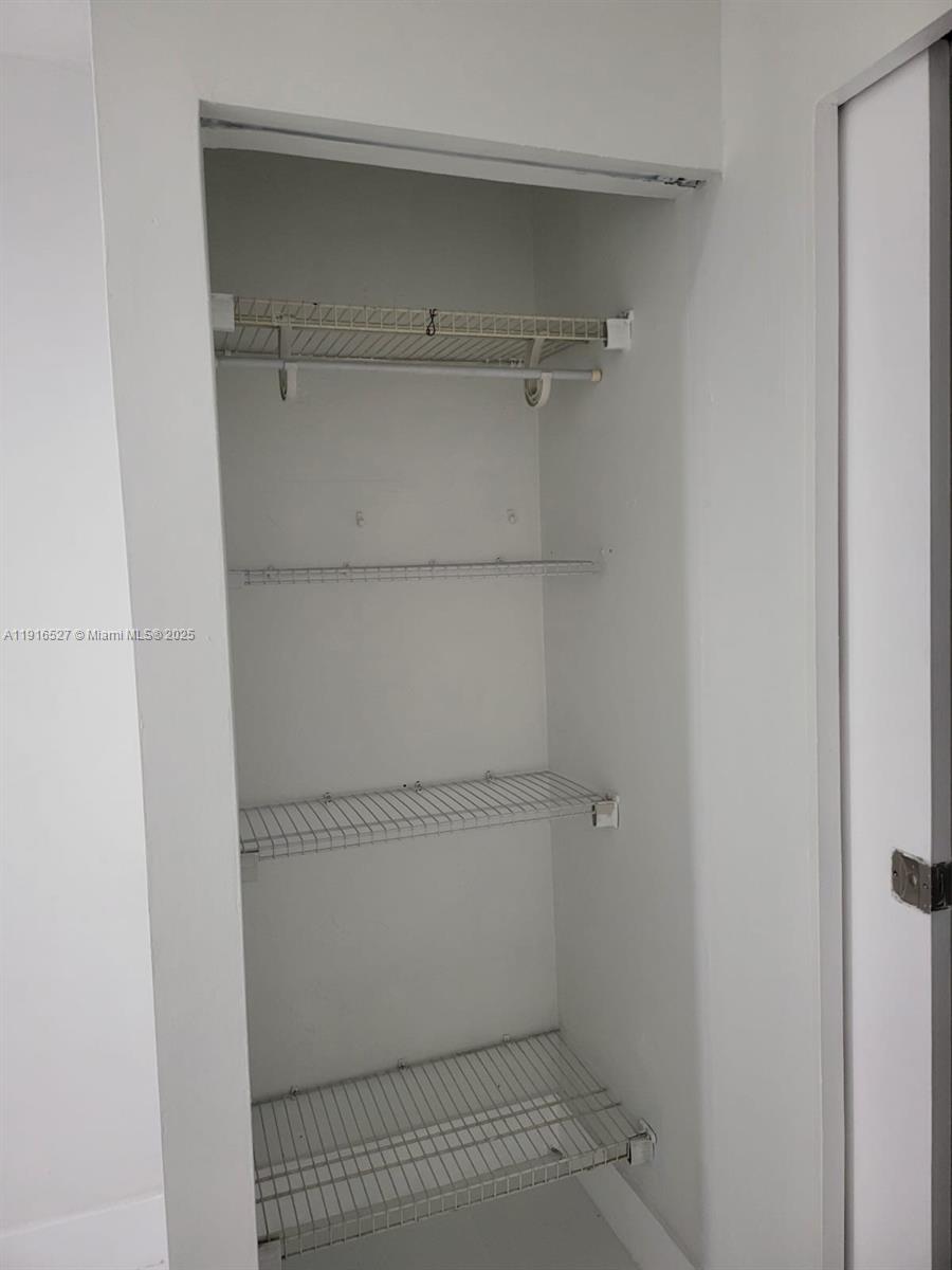 This closet features white walls and four levels of white wire shelving — 9375 SW 40th Ter # 203, Miami FL 33165, MIAMI, FL