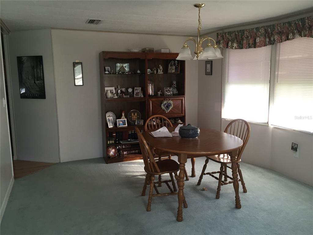 A kitchen with white appliances, white cabinets, and light-colored tile flooring — 3438 BANBERRY CIRCLE UNIT 1790, ZELLWOOD, FL