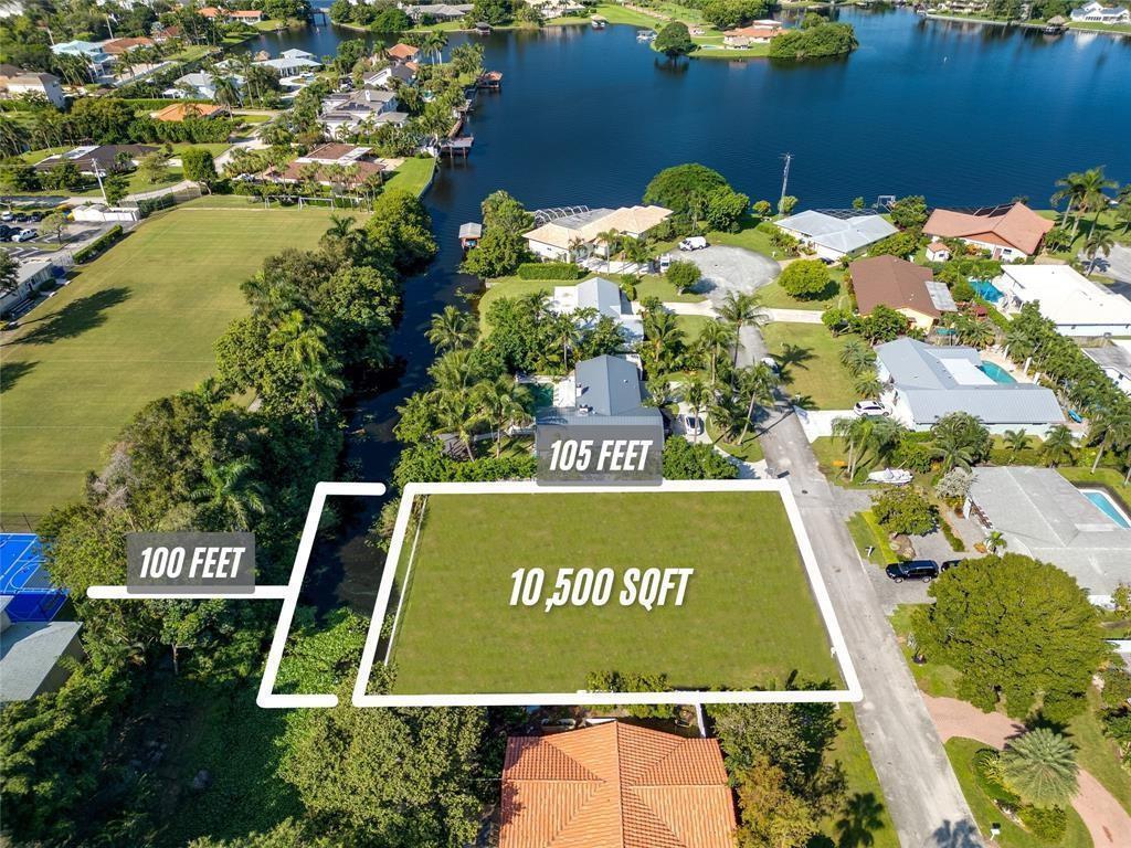 An aerial view shows a vacant rectangular residential lot outlined in white near a canal — 8 NW 24th Street, Delray Beach FL 33444, DELRAY BEACH, FL