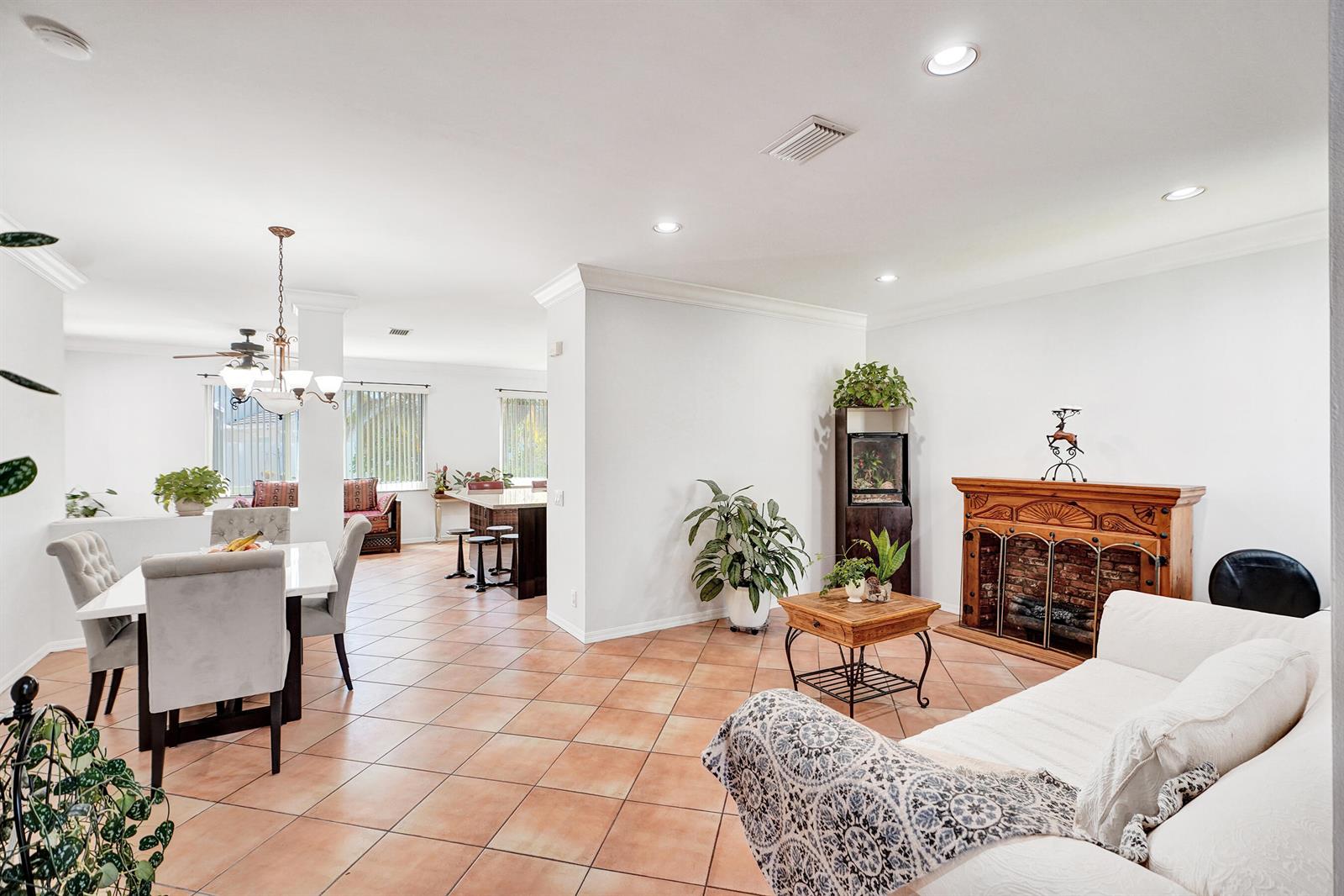 A two-story suburban house with a two-car garage, tile roof, and mature trees in front — 873 Stanton Drive, Weston FL 33326, WESTON, FL