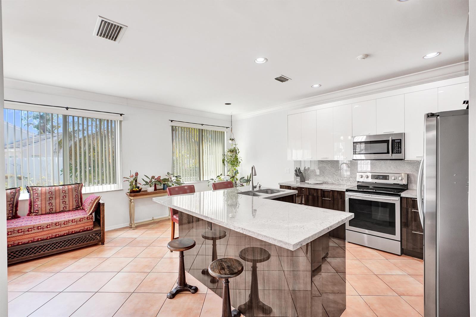A two-story suburban house features a white garage, a paved walkway, and manicured landscaping — 873 Stanton Drive, Weston FL 33326, WESTON, FL