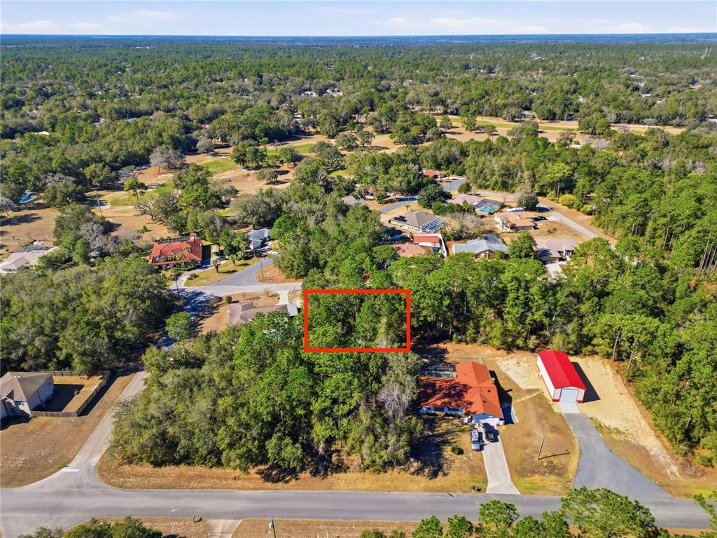 An aerial view shows a wooded residential lot outlined in red next to a house — 2780 W ELGIN PLACE, CITRUS SPRINGS, FL