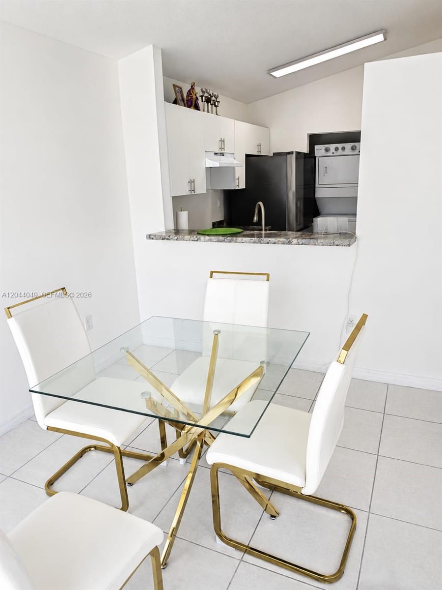 A dining area features a glass-topped table with gold legs and white chairs — 17834 SW 144th Ct # 0, Miami FL 33177, MIAMI, FL