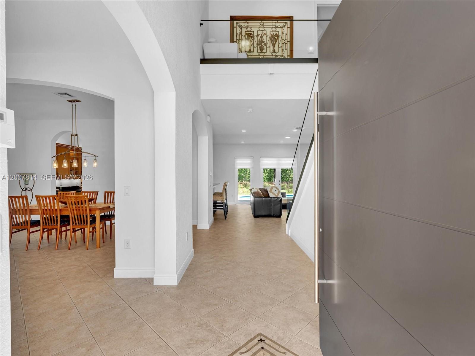 A view from an entryway looking into a dining room and a living area — 4961 SW 173rd Ave, Miramar FL 33029, MIRAMAR, FL