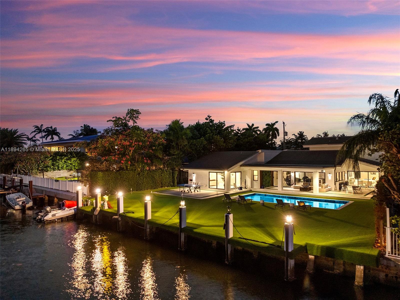 An aerial view of a waterfront house with a swimming pool and a manicured lawn — 207 Holiday Dr, Hallandale Beach FL 33009, HALLANDALE BEACH, FL