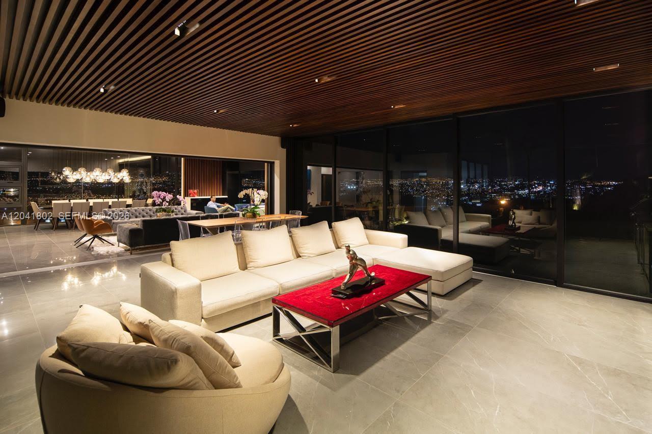 A modern living room features a large sectional sofa, a red coffee table, and floor-to-ceiling windows — 37-3 ESCAZU, CR 1556-M-000, CR