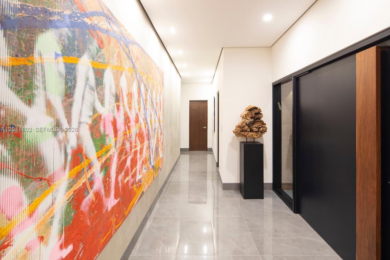 A hallway features large abstract art, a wooden sculpture on a pedestal, and tiled floors — 37-3 ESCAZU, CR 1556-M-000, CR