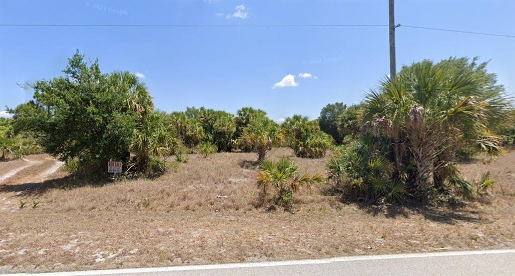 A vacant, grassy lot with scattered palm trees and a for sale sign — 366 SALISBURY STREET, PORT CHARLOTTE, FL