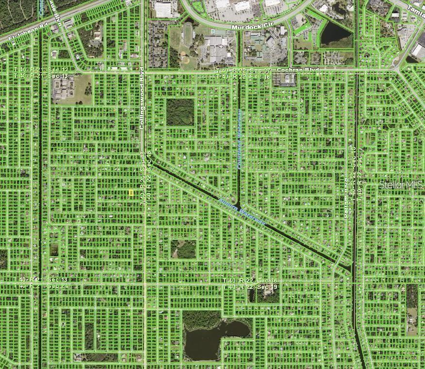 This is an aerial map view of a residential neighborhood with a canal running through it — 17497 GRANBY AVENUE, PORT CHARLOTTE, FL