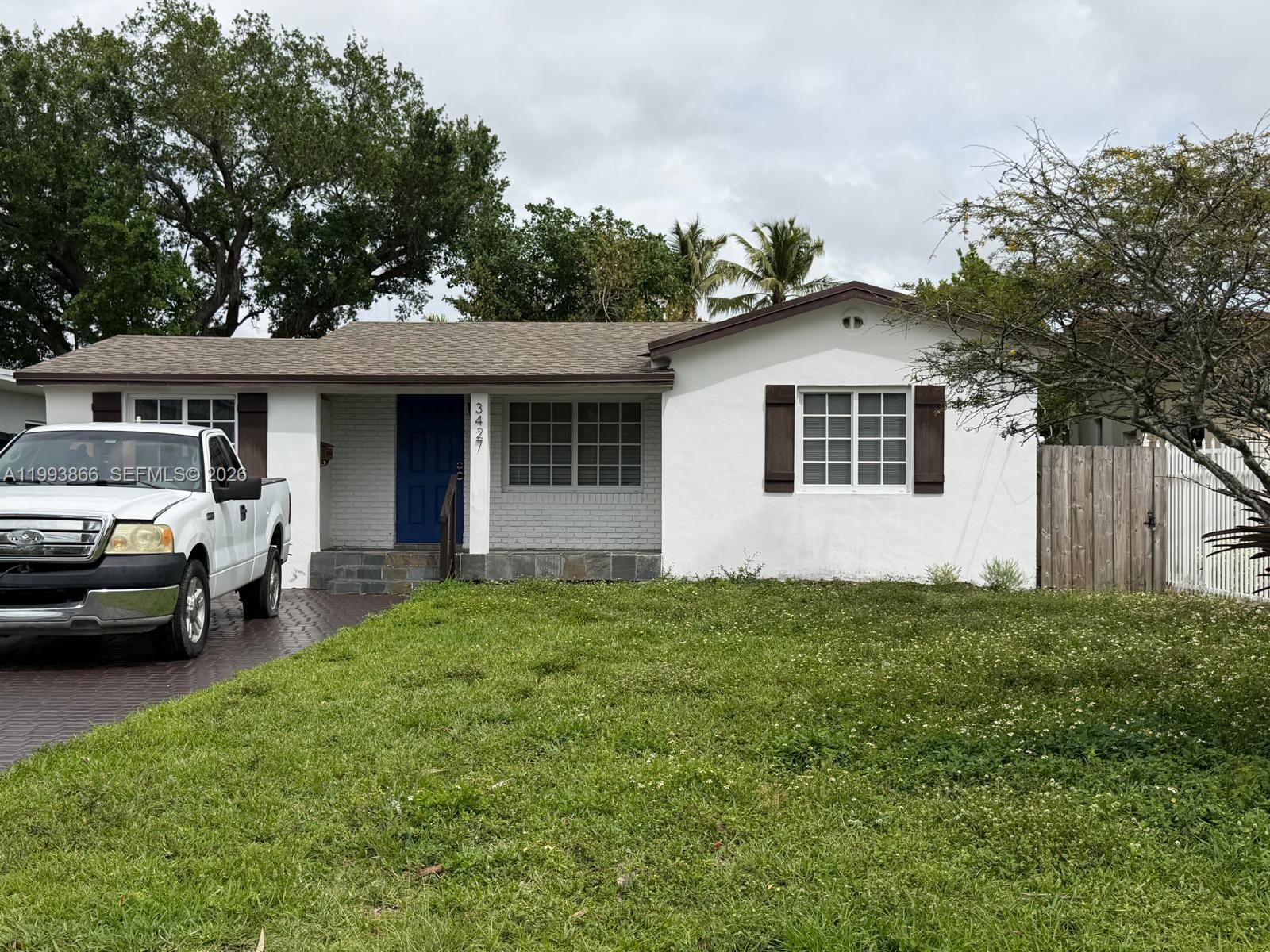 A single-story house with white stucco walls, a blue front door, and a brick facade — 3427 SW 64th Ave, Miami FL 33155, MIAMI, FL