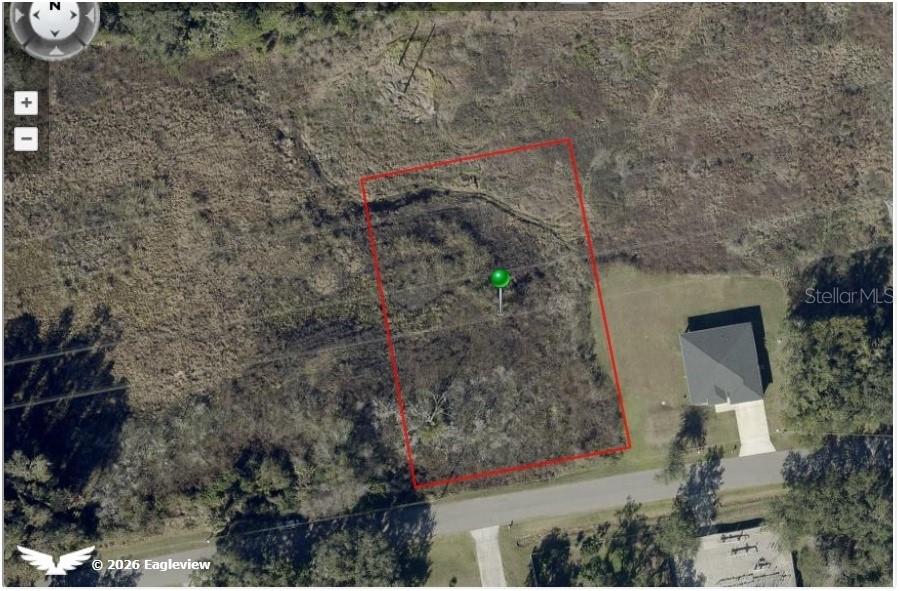 An aerial view shows a vacant rectangular plot of land outlined in red — 274 TOMS ROAD, DEBARY, FL