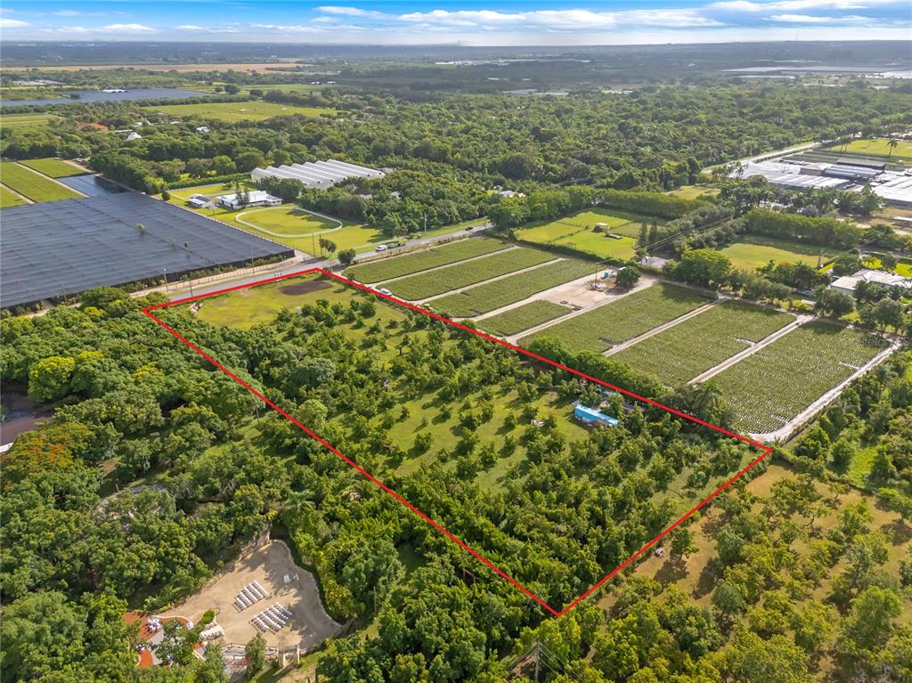An aerial view shows a rectangular plot of land outlined in red featuring scattered trees — 15300 SW 216TH, MIAMI, FL