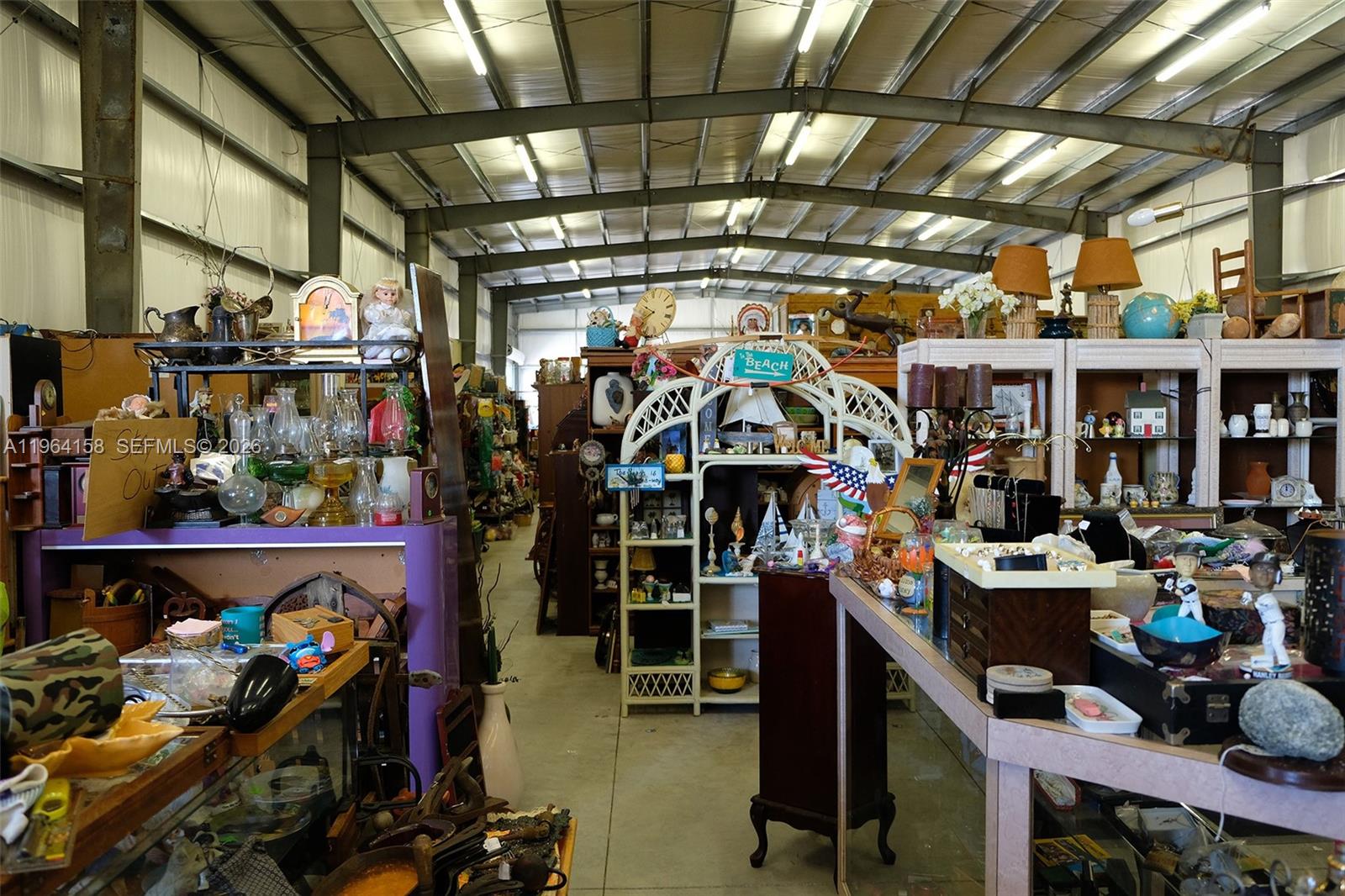 A large, cluttered warehouse space filled with various antiques, furniture, and miscellaneous household items — 5271 US HWY 441 SE, Okeechobee FL 34974, OKEECHOBEE, FL