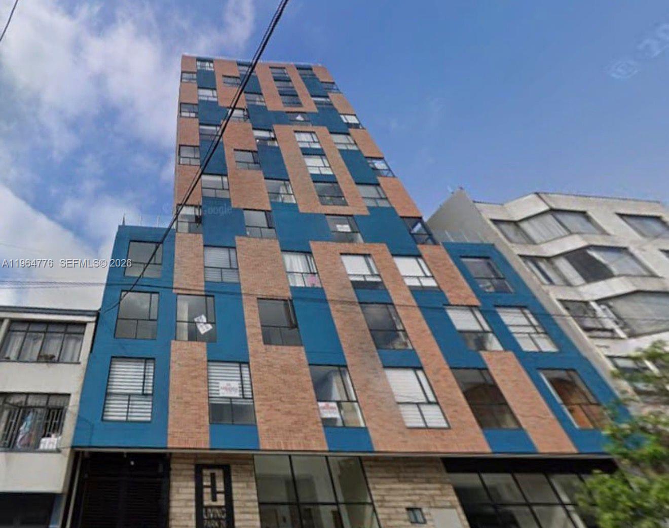 A modern multi-story apartment building features a facade with alternating blue and brick-patterned panels — Calle 25 C 37-37 Apto 601 Calle 25 C # 601, FL
