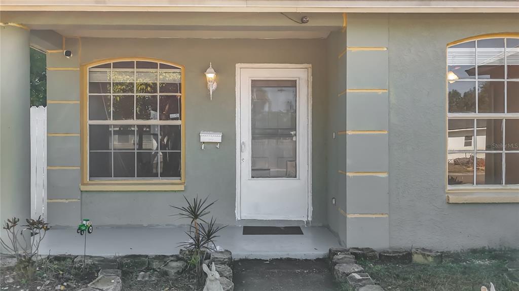 A single-story house with a gray exterior, a concrete driveway, and a front yard — 1926 29TH AVENUE N, ST PETERSBURG, FL
